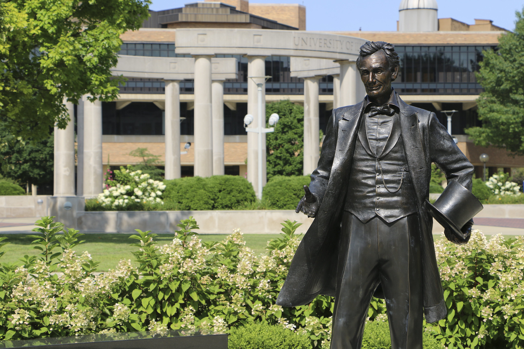 The Lincoln Statue on campus with the Colonnade in the background