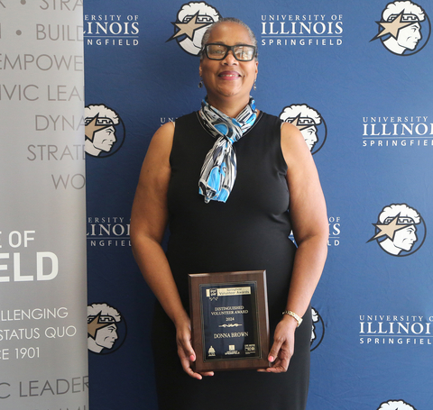 Donna Brown posing with her award