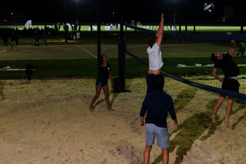 students playing sand volleyball