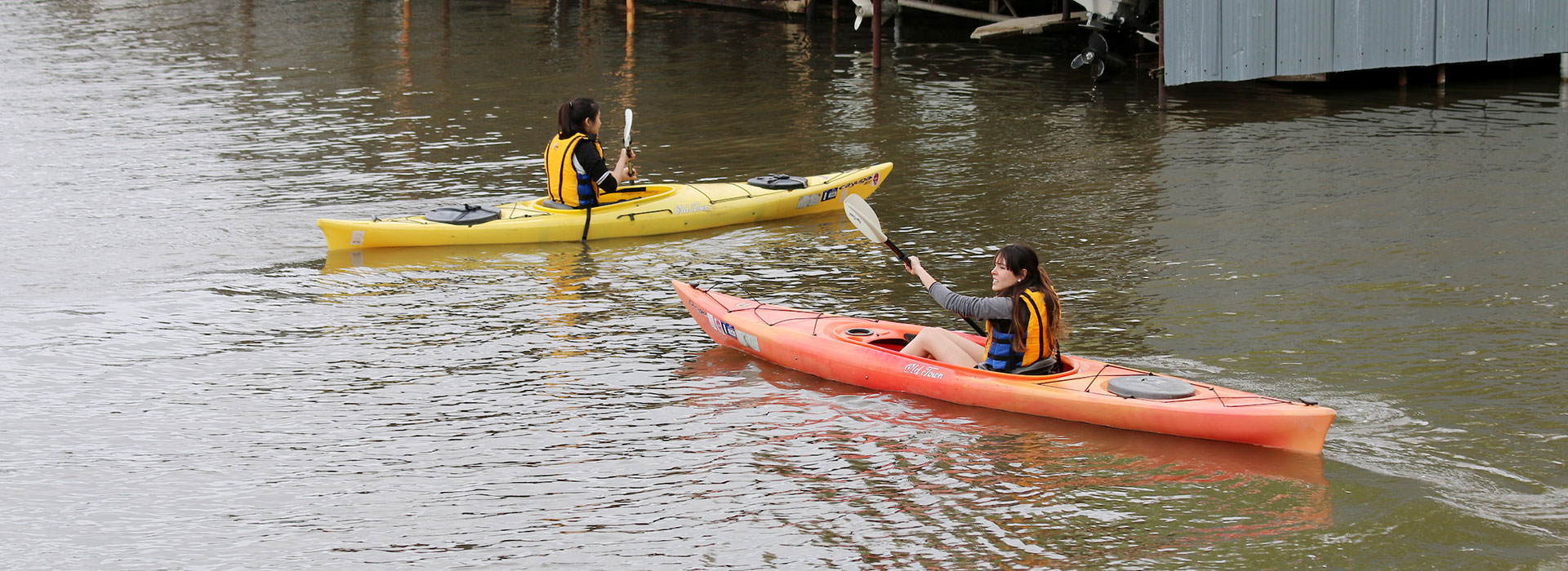 students kayaking lake