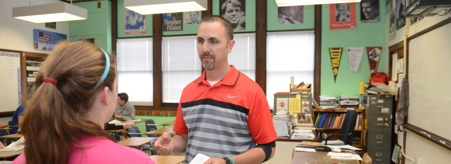 a teacher talking to a middle school student