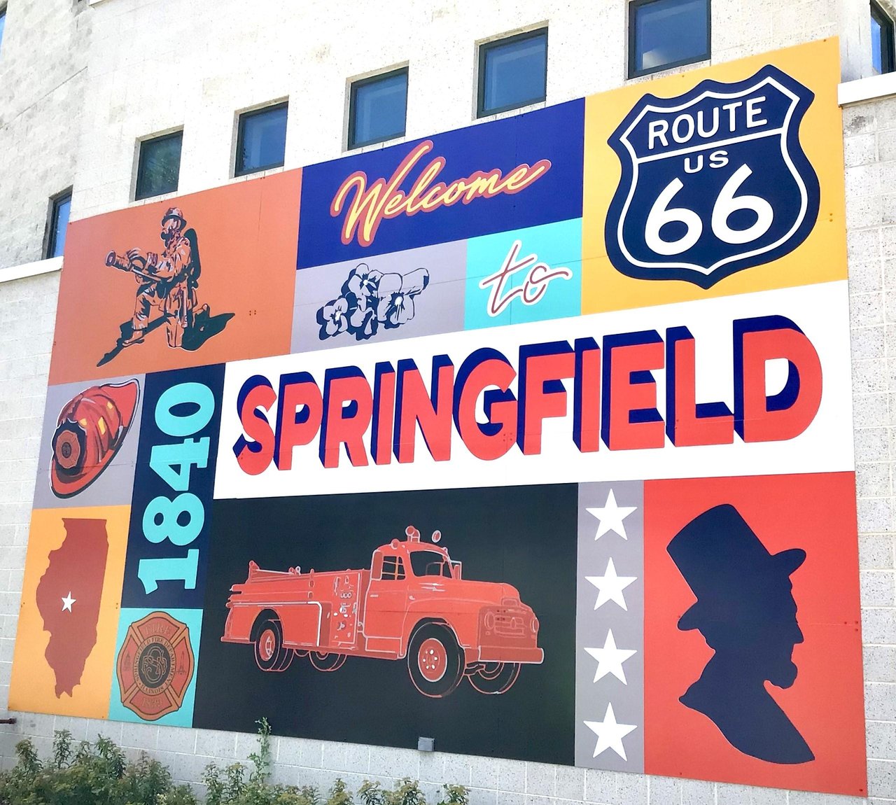 Colorful mural featuring Springfield, Route 66, a firetruck, and Abraham Lincoln.