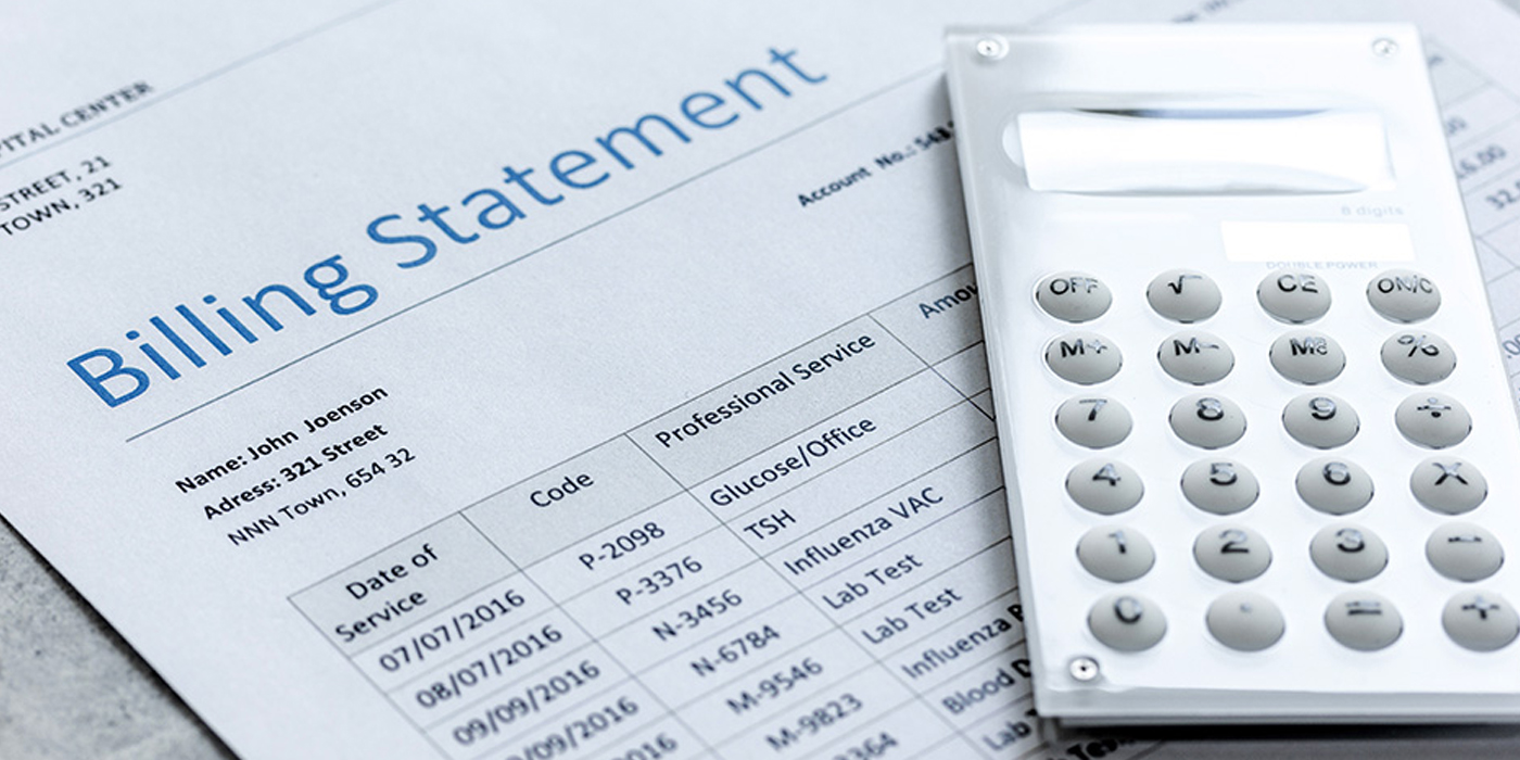 Billing statement with calculator on table.