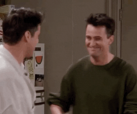 Joey and Chandler from Friends hug.