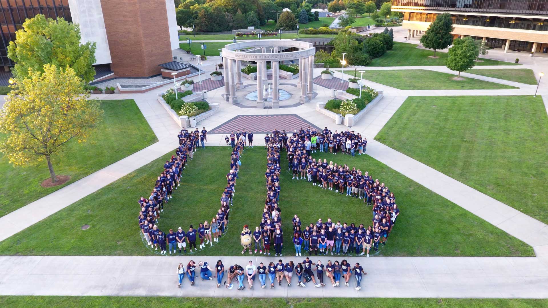 the colonnade in the background with UIS spelled in people in the foreground