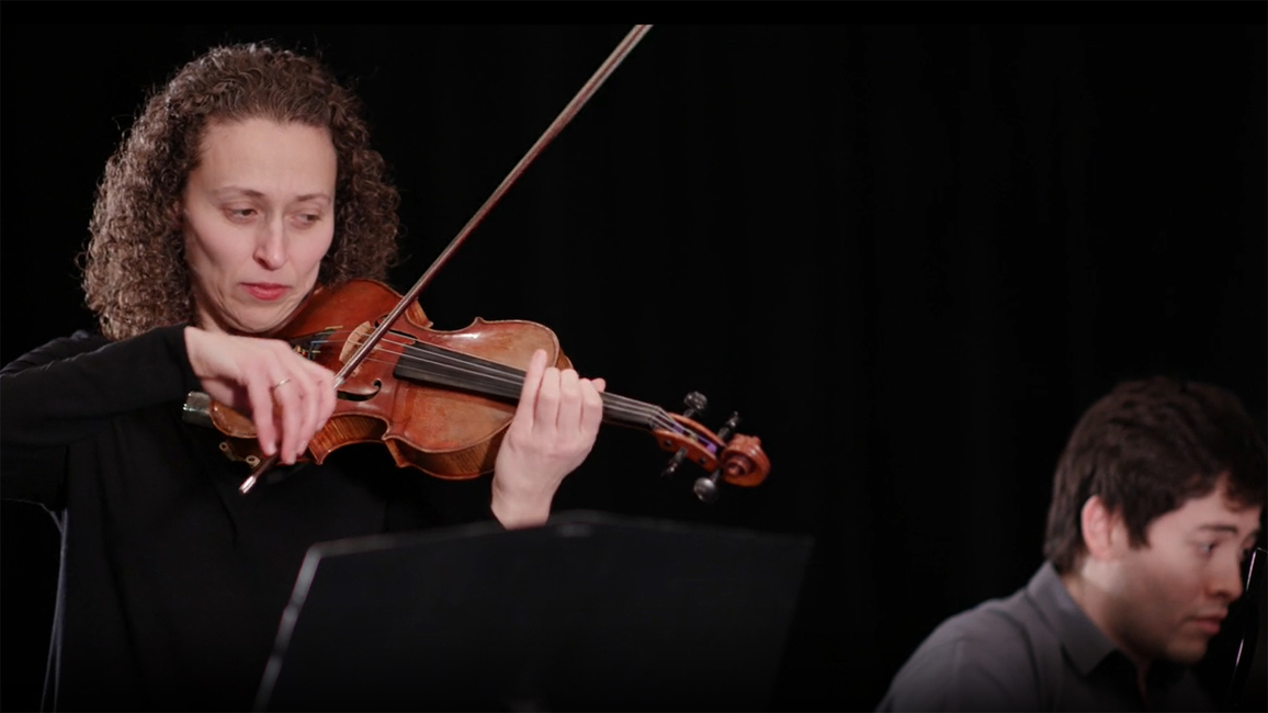 Yona Stamatis playing a violin