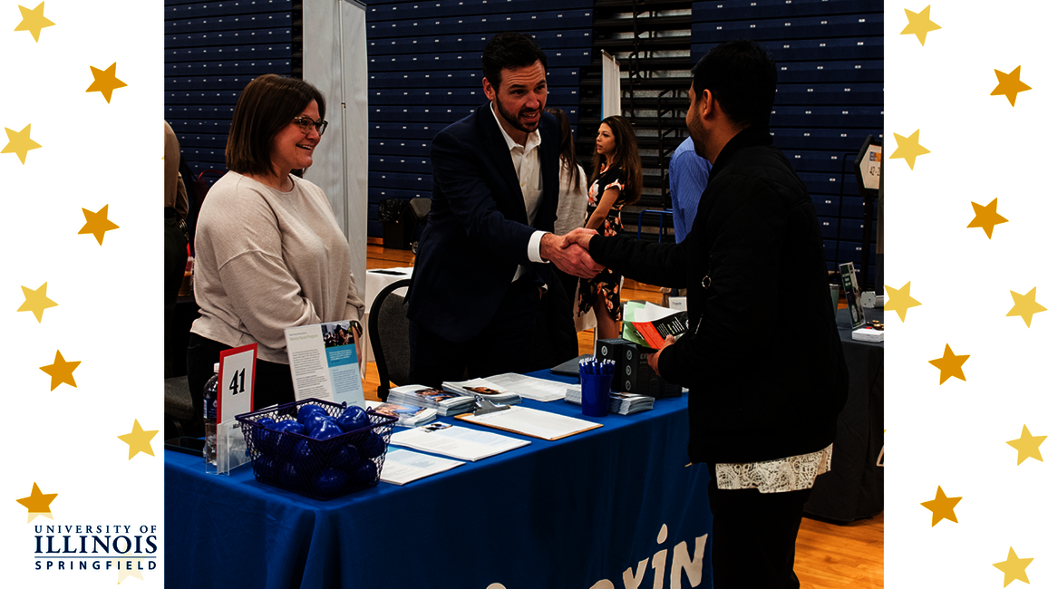 An employer meeting a student at a job fair.