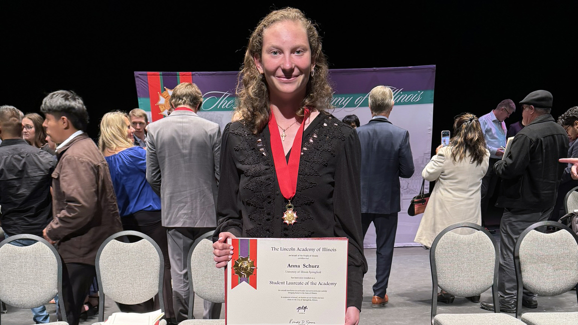 Anna Schurz holding the award