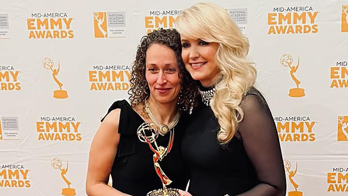 Yona Stamatis and Julie Staley holding the Emmy award.