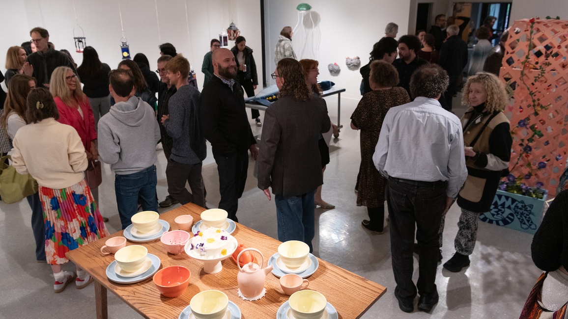 A group of people gathered to view art in the gallery.