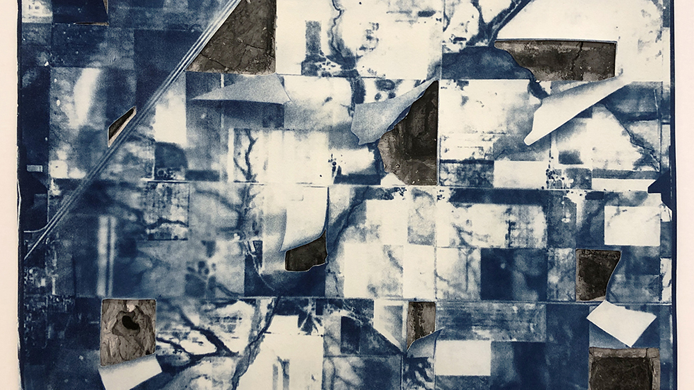 Abstract artwork with a grid of blue and white patches, featuring torn paper and exposed areas revealing different textures underneath.