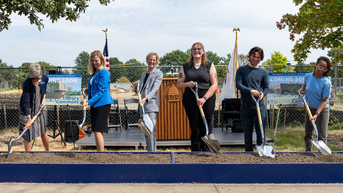 UIS leaders and students turn dirt with shovels to celebrate the Library Commons groundbreaking on the quad.