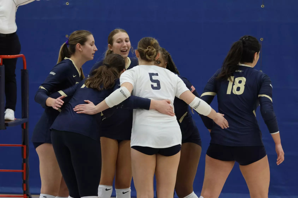 Volleyball Team huddle after a point