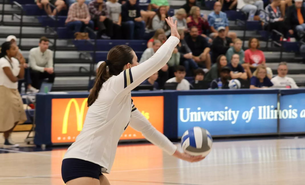 Makenna Cox serving in volleyball