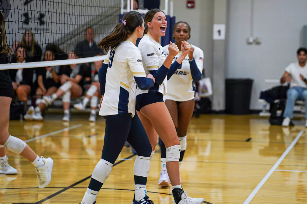 Carly Michels, Makenna Cox, and Erica Sledge celebrate scoring a point