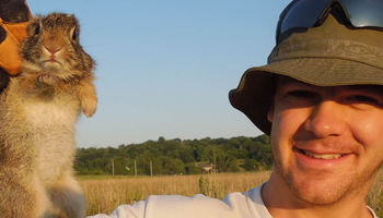 a man holding a small animal