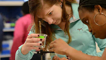 chemistry students performing an experiment