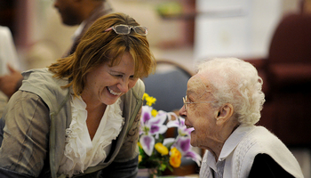 woman speaking with elderly woman