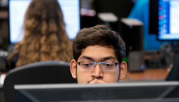 student behind computer screen