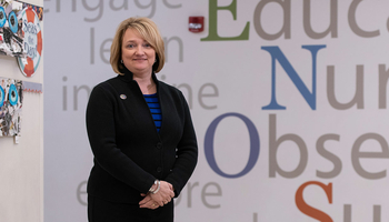 teacher in front of word wall