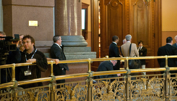 several people at the railing of the second floor of the Illinois Capitol Building