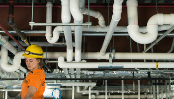 student looking at pipes