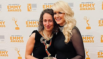 Yona Stamatis and Julie Staley holding the Emmy award.