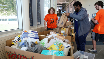 Students put collected food inside bins