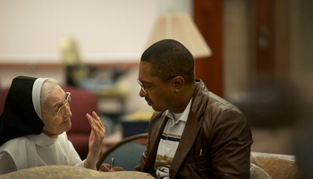 student talking to older nun