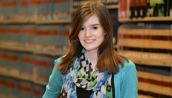 student in front of law books