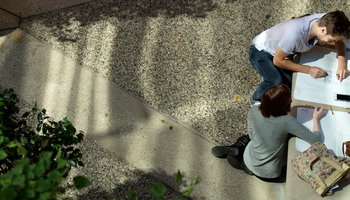 Overhead view of two students working on creative group project together