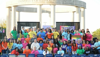 Group of people outside celebrating National Coming Out Day