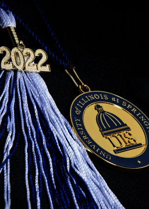 Black graduation cap with a blue and white 2022 tassle