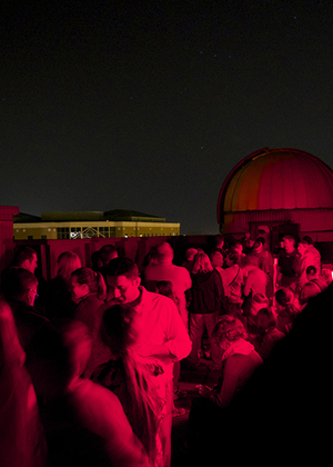 A crowd of people on the roof of Brookens Library for a Star Party.