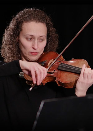 Yona Stamatis playing a violin