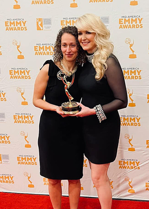 Yona Stamatis and Julie Staley holding the Emmy award.