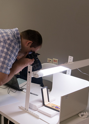 A student takes a photo of a historical artifact.