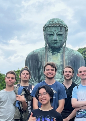 John Linville is pictured with six UIS students during a study abroad trip to Ashikaga, Japan in 2024. Those pictured are standing in front of a statue.