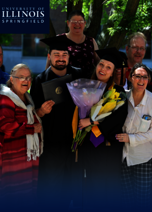 A family taking a picture at graduation.