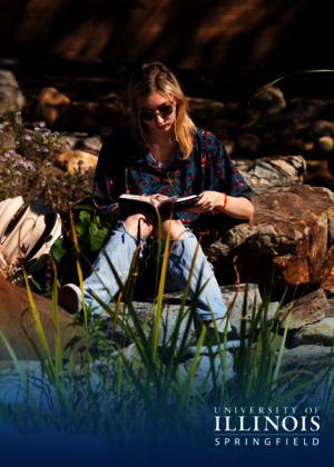 Student reading by the Koi Pond.