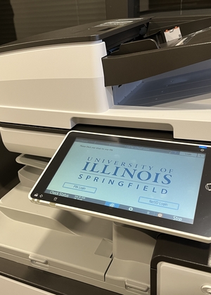 Printer with a touchscreen display featuring a university logo.