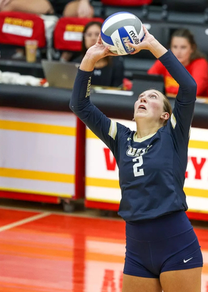 Madi Siefken playing volleyball in blue UIS uniform