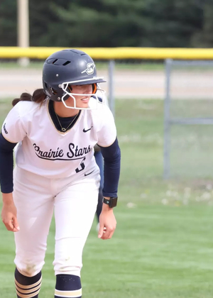 Jaden Watts playing softball in white UIS uniform