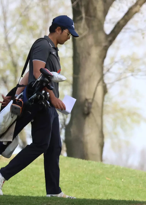 Sahachat "Chevy" Noosong walking the golf course