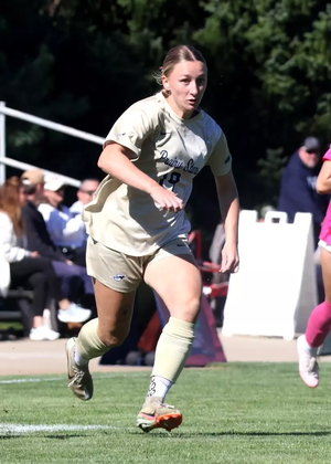 Bridget Lyons playing soccer in UIS gold