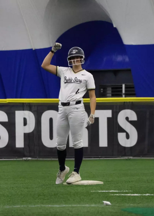 Bailey Masching on second base in white UIS softball uniform