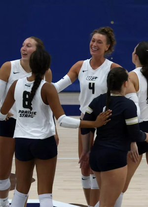 Volleyball huddle including Kaitlyn Taylor