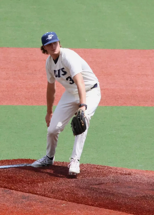 Ben Benoit pitching in white UIS uniform
