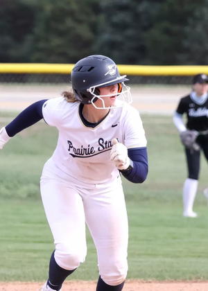 Rachel McMullen running the bases in white UIS softball uniform