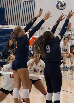 UIS volleyball players blocking